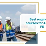 Two professional engineers discussing engineering courses for Australian PR at railway construction site wearing safety equipment and reviewing project documentation.